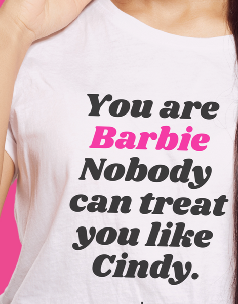 BARBIE White Y Day Apparel T-shirt with fun affirmation foodie slogan on the front: You are Barbie Nobody can treat you like Cindy in ORANGE font. It’s celebrates self worthiness. Available to Purchase from Y Day Apparel.com