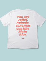 White Y Day Apparel T-shirt with fun foodie slogan on the back: You are Jollof. Nobody can treat you like Banana, in ORANGE font. It’s celebrates self worthiness. Available to Purchase from Y Day Apparel.com